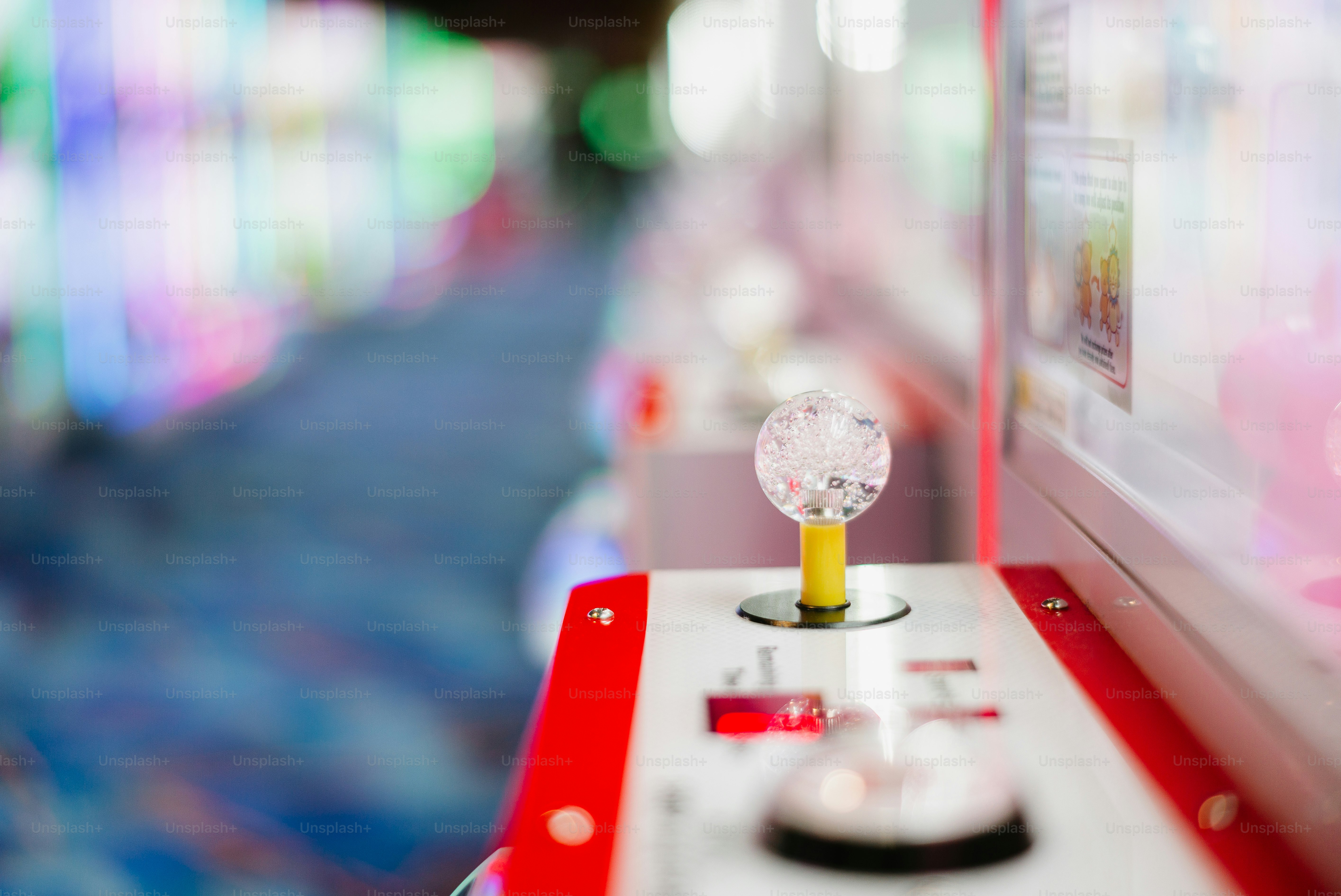 A claw machine's joystick is shown.